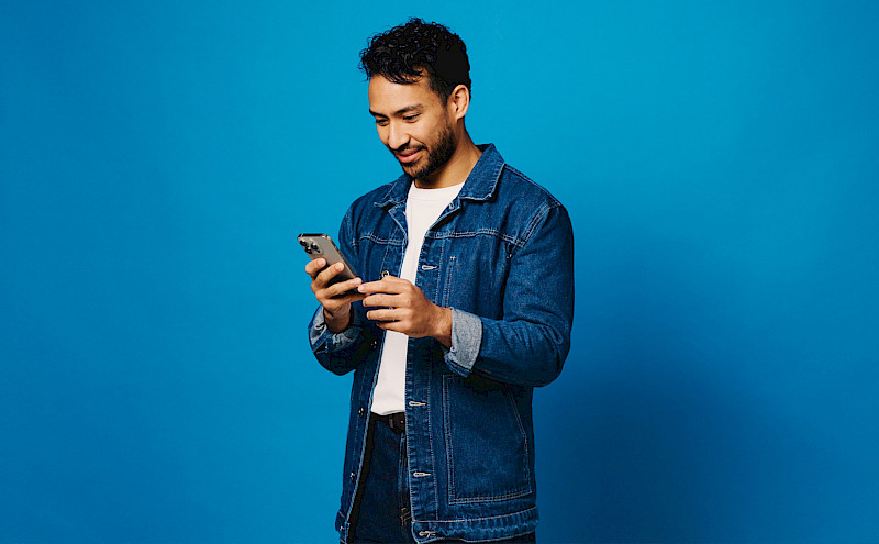 Eine Person schaut in Ihr handy und betrachtet die Ergebnisse des Digitalen Checks seinen Unternehmens